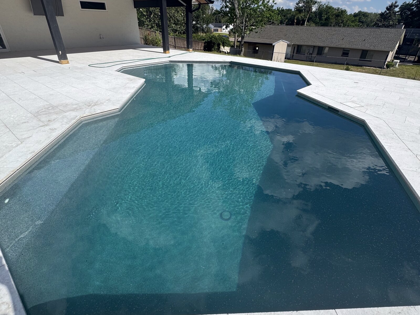 Freeform resort-style pool with covered patio and travertine decking, Central Florida